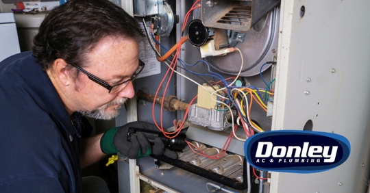 Man checking furnace in the basement
