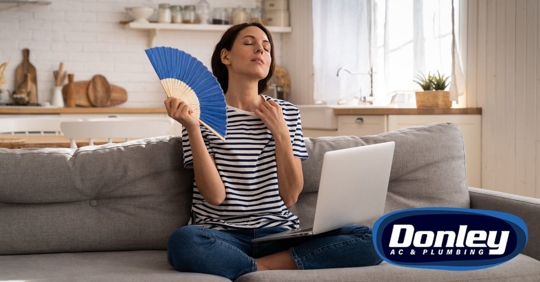 Woman fanning herself in summer home
